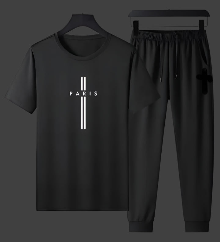 Black t-shirt and pants set with 'PARIS' print on a gray background