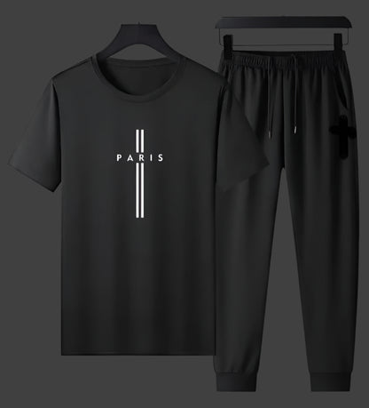Black t-shirt and pants set with 'PARIS' print on a gray background
